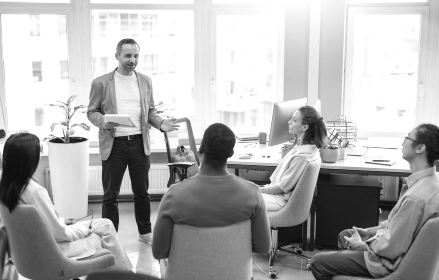 Professional presenting financial data to engaged business team